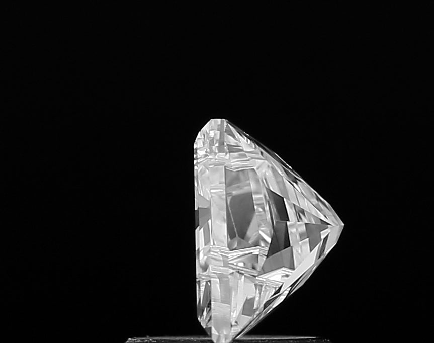 Macro shot highlighting the incredible fire and sparkle of a premium lab grown Alphabet M shape cut diamond, with precisely aligned facets.