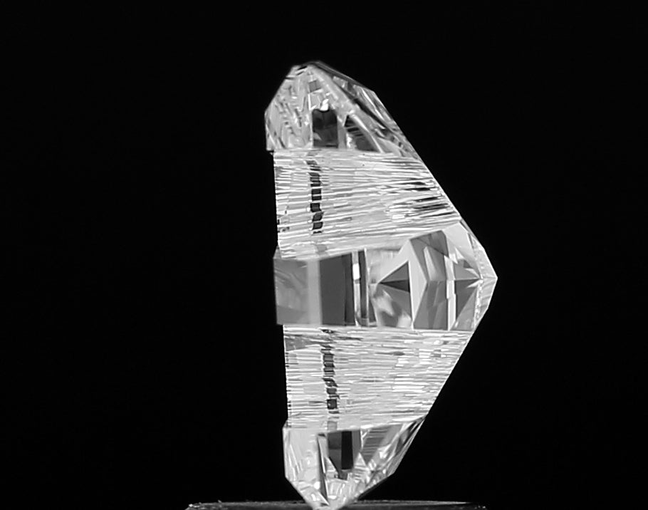 Macro shot highlighting the incredible fire and sparkle of a premium lab grown Alphabet E shape cut diamond, with precisely aligned facets.